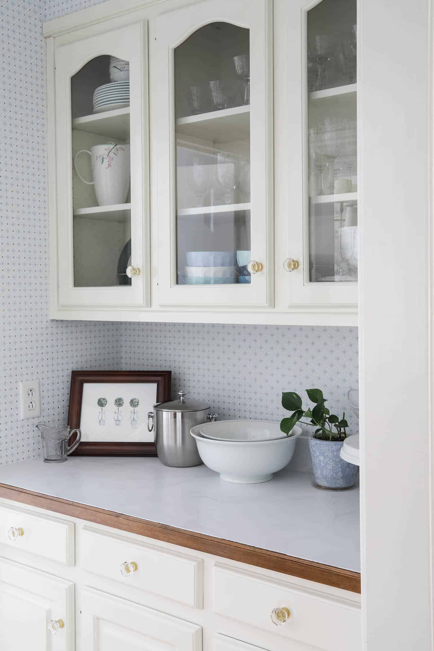 butler's pantry with painted marble-like countertops.
