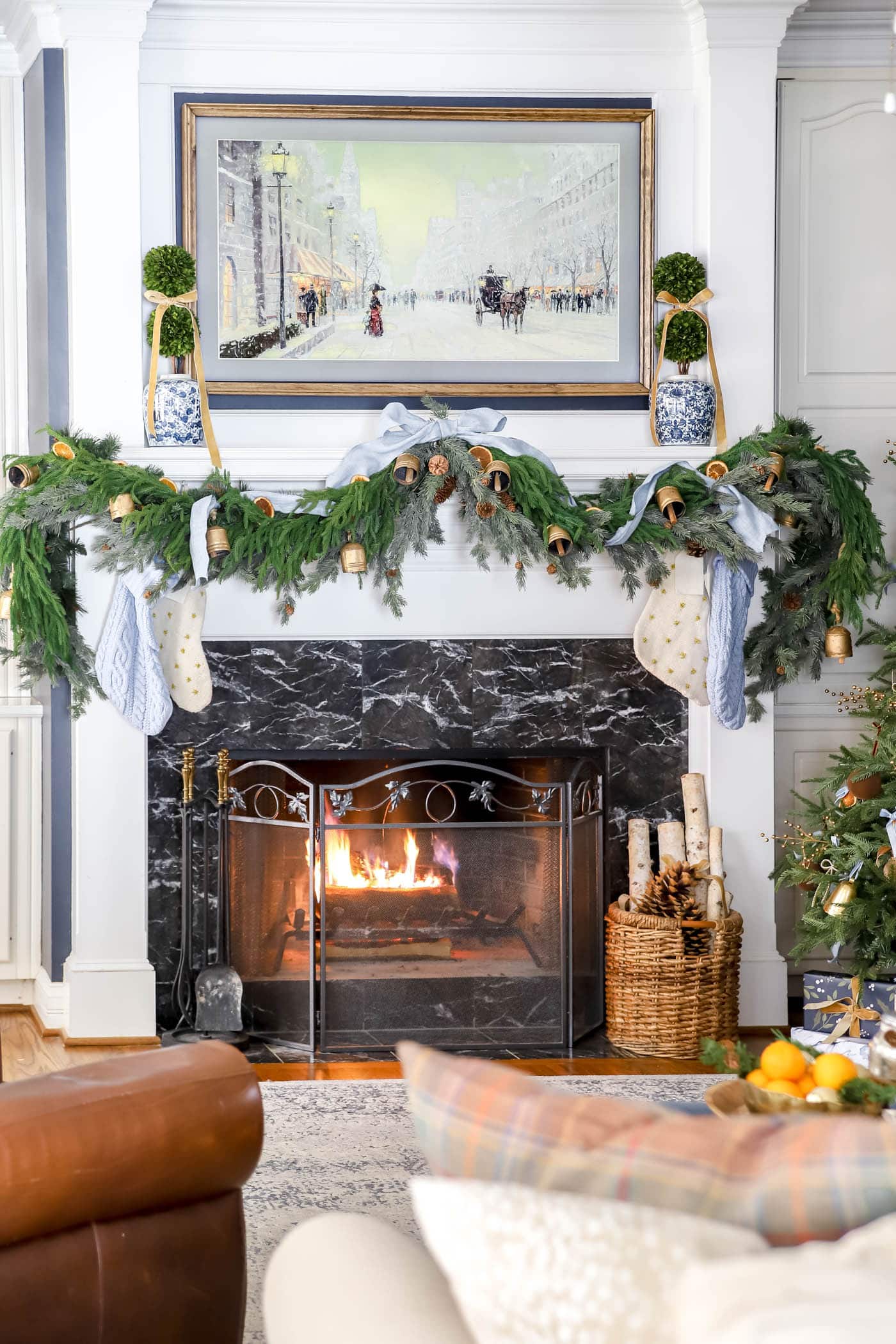 Christmas mantel with blue and orange decor.
