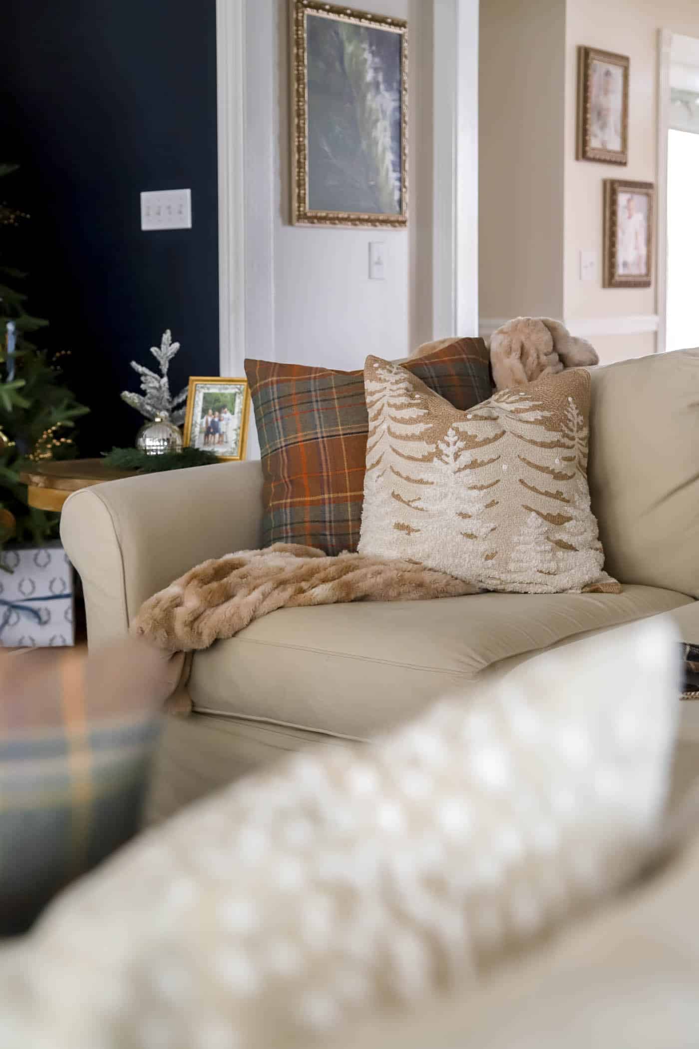 brown and orange plaid pillow and wintery scene pillow cover.