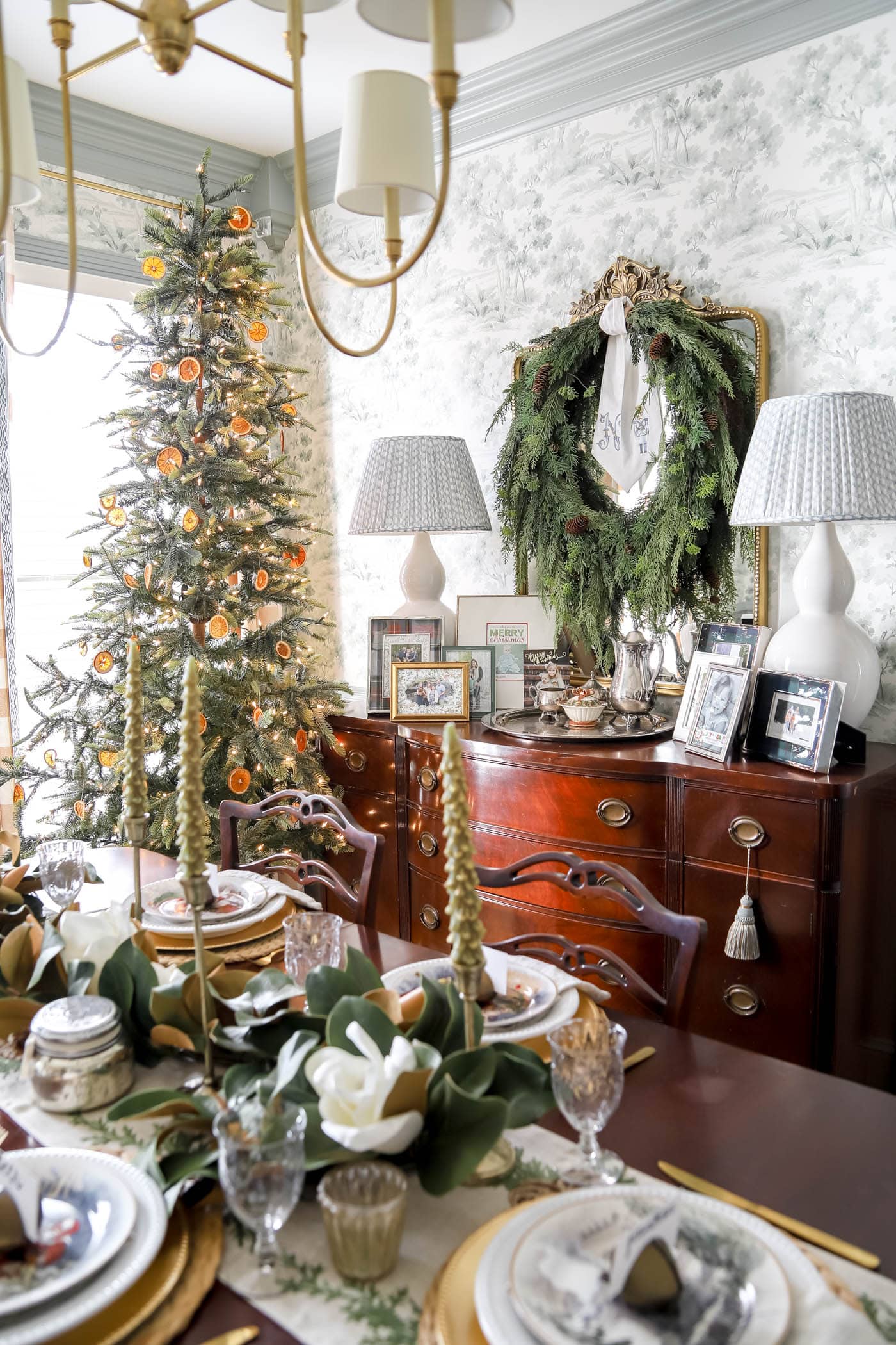 large mirror with wreath over it for Christmas in the dining room.