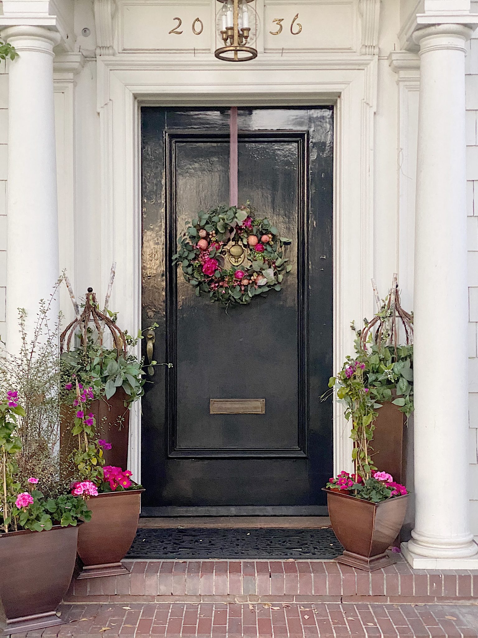 small front stoop with lots of flowers and greenery from 100 Year Old Home