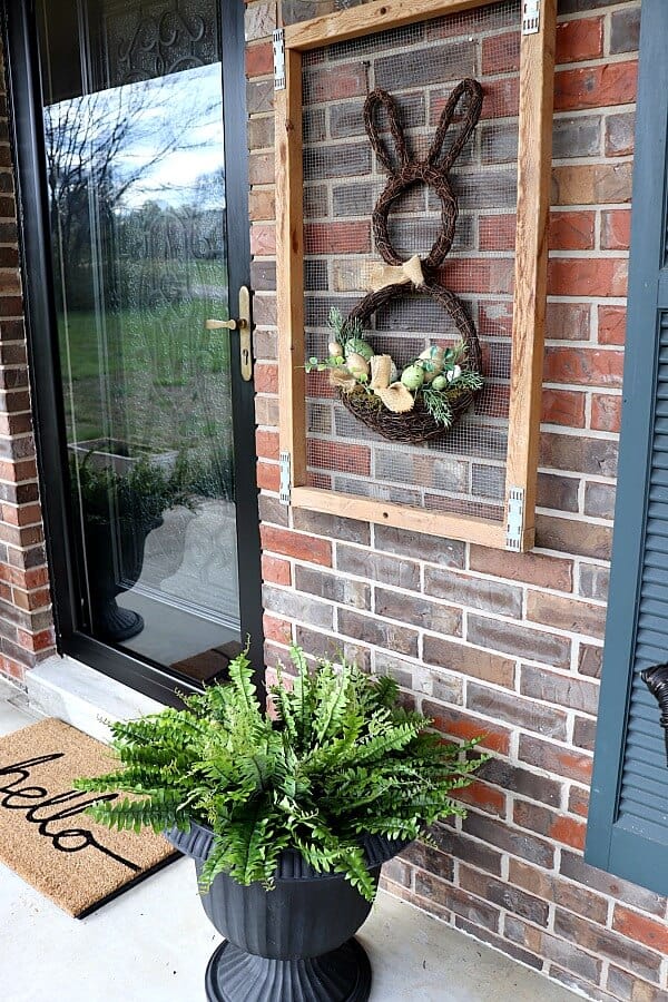 spring wall decor on a small front porch.
