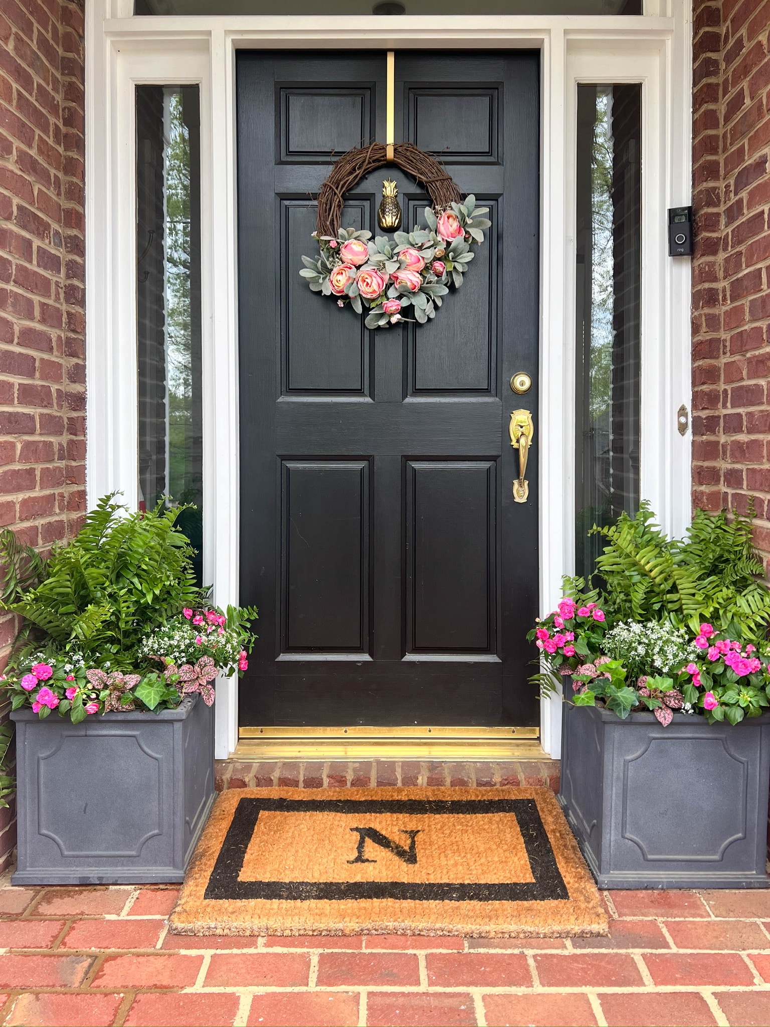 Planters with spring flowers on small front porch