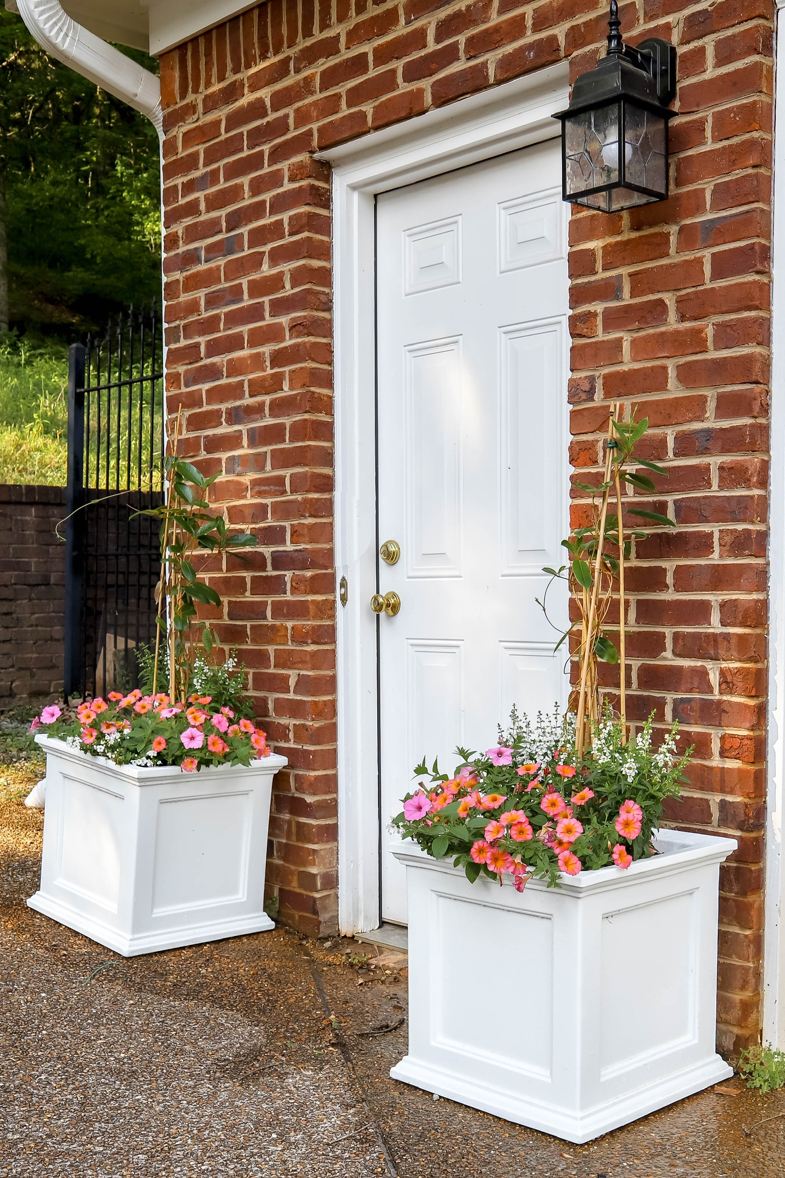 brick house with white planters flanking back door