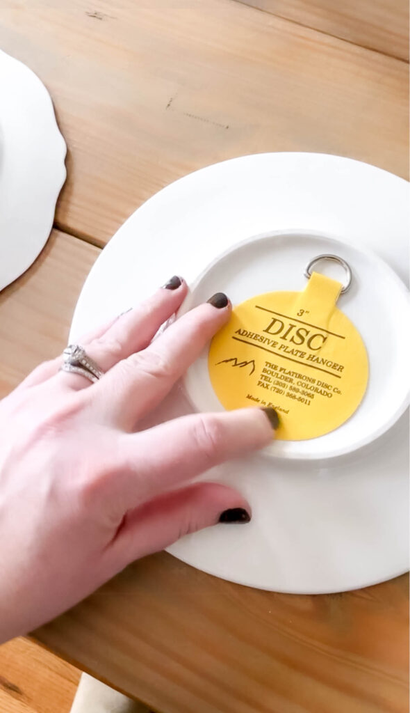 press on the back of the adhesive plate hanger to make sure it's well adhered.