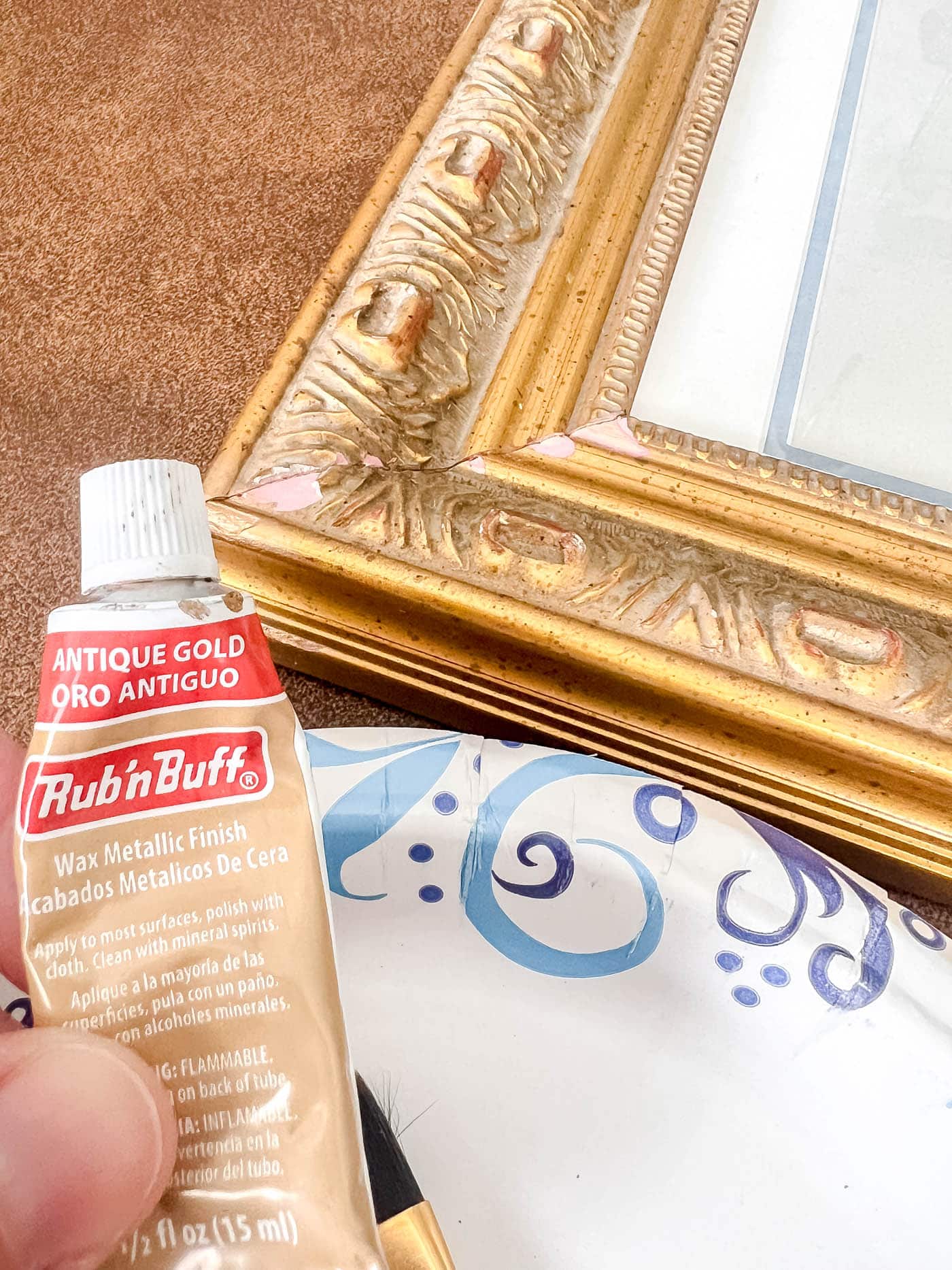 rub n buff foxed a chipped ornate frame.