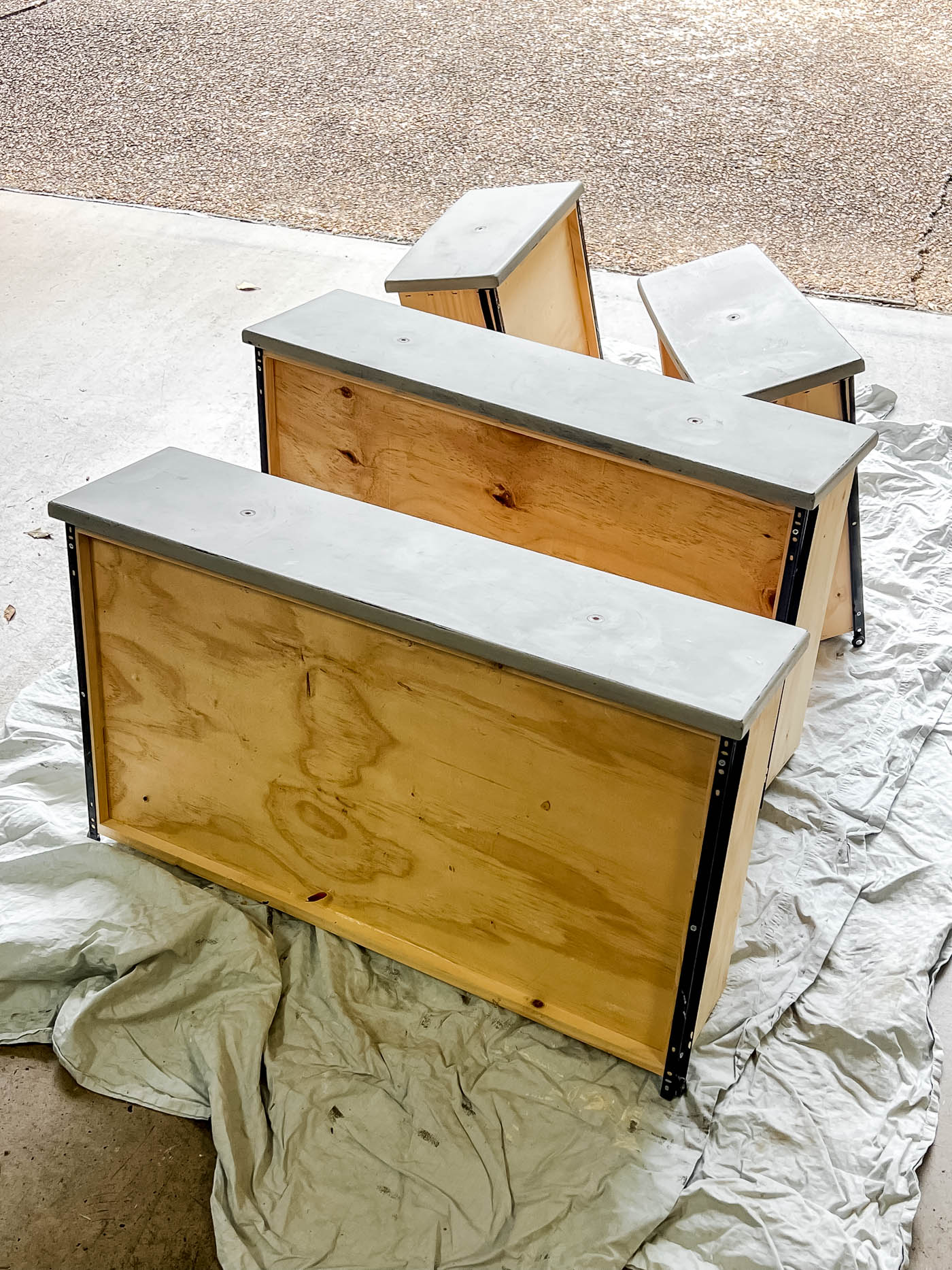 Drawers removed from dresser in the garage floor.