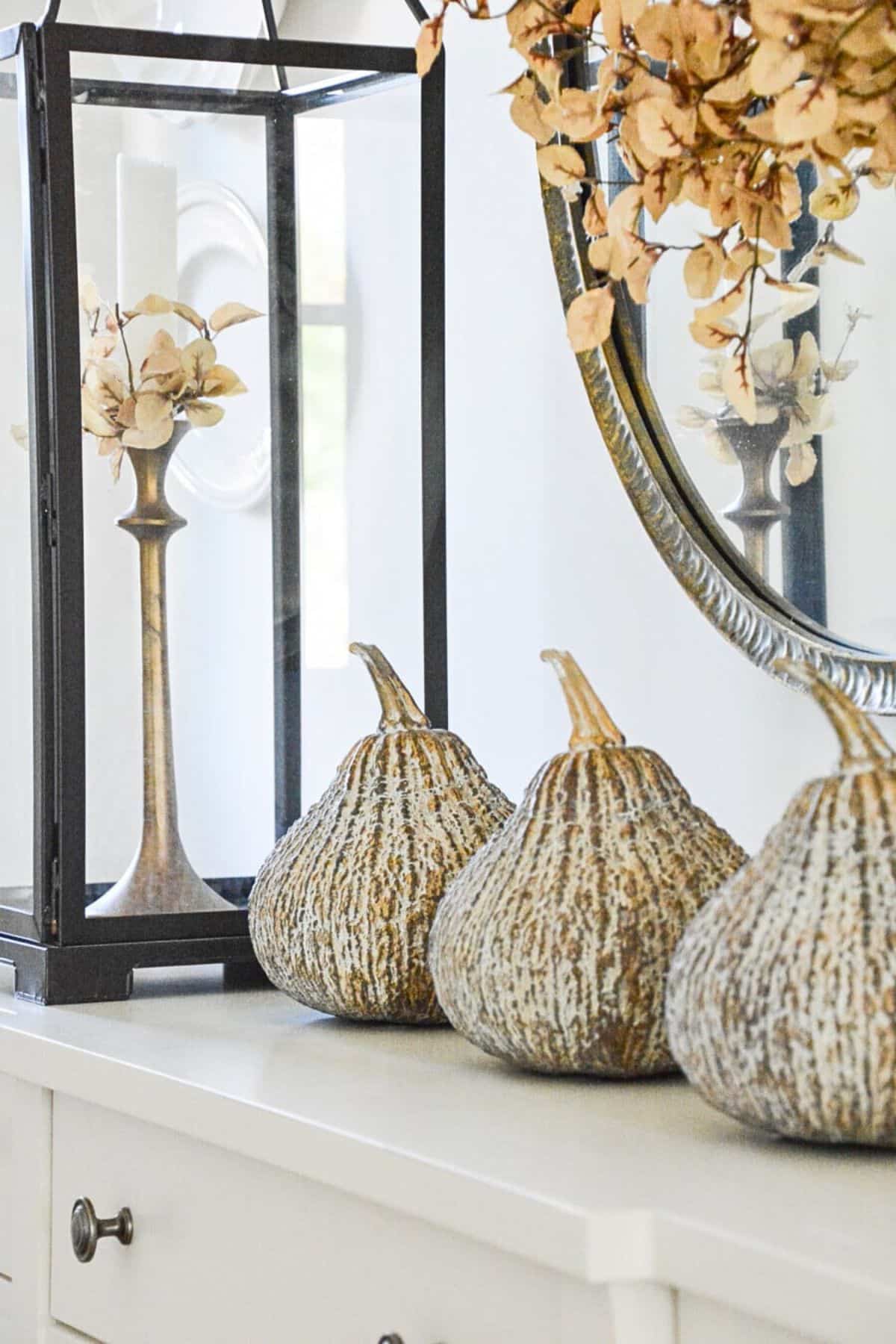 concrete gourds and lantern for fall decor.