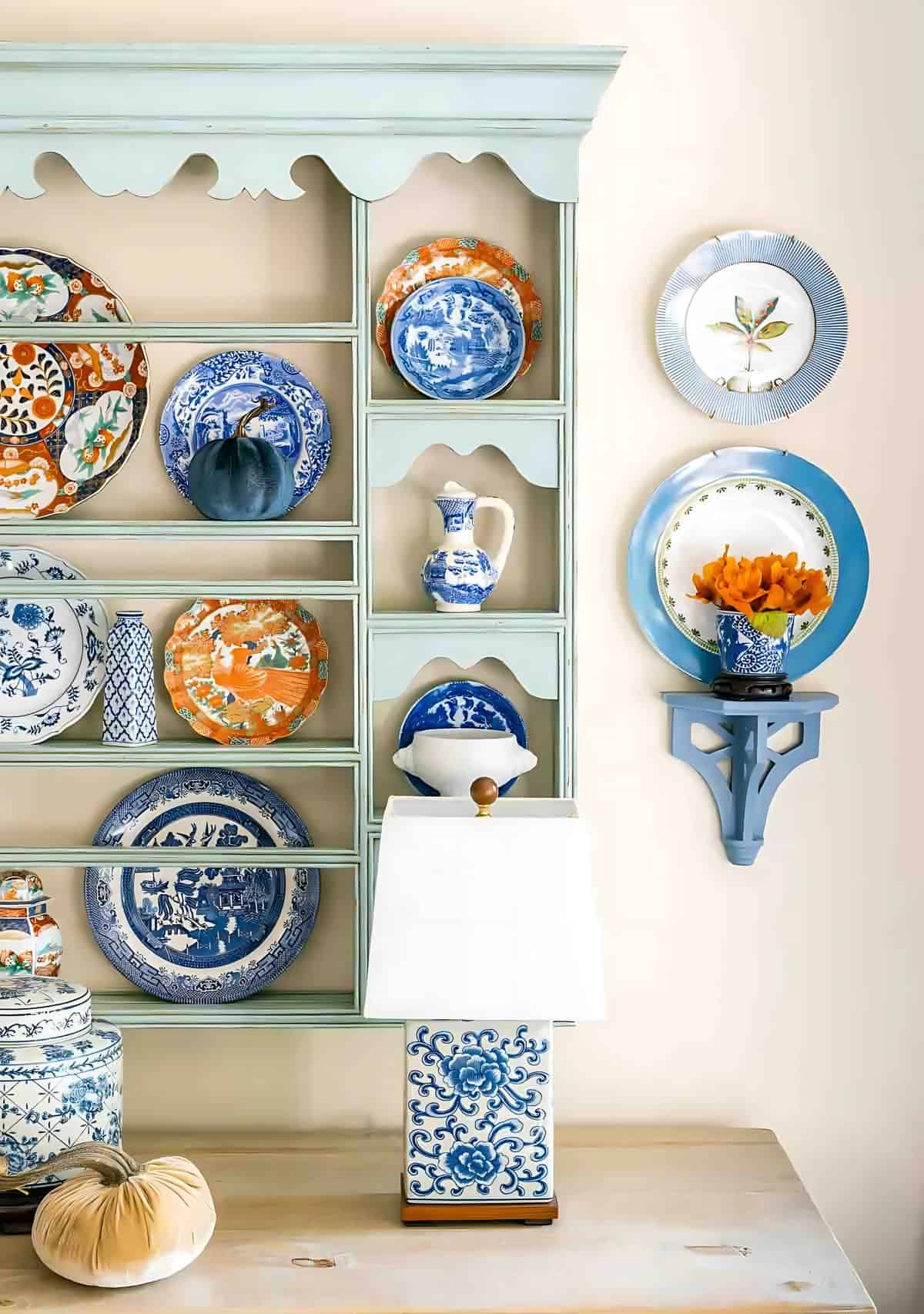 blue and white plates in a plate rack and on the wall.