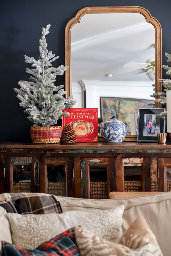 The night before Christmas leather bound book on a shelf with blue and white chinoiserie pot and a faux potted flock christmas tree.