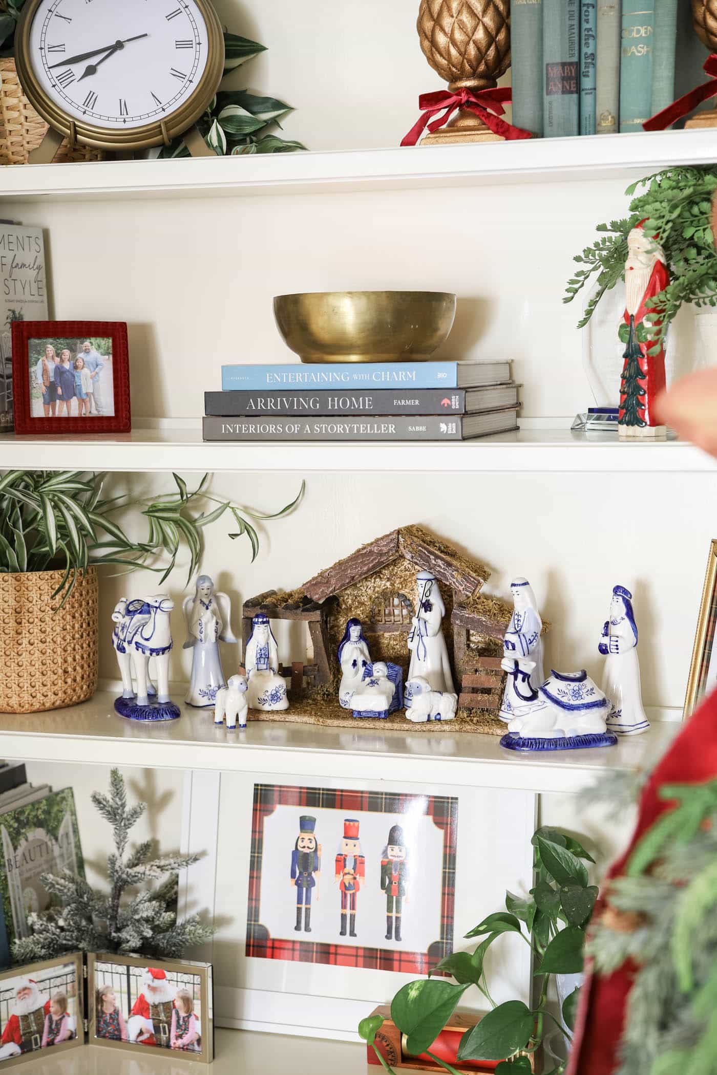 blue and white nativity on bookshelf for Christmas.