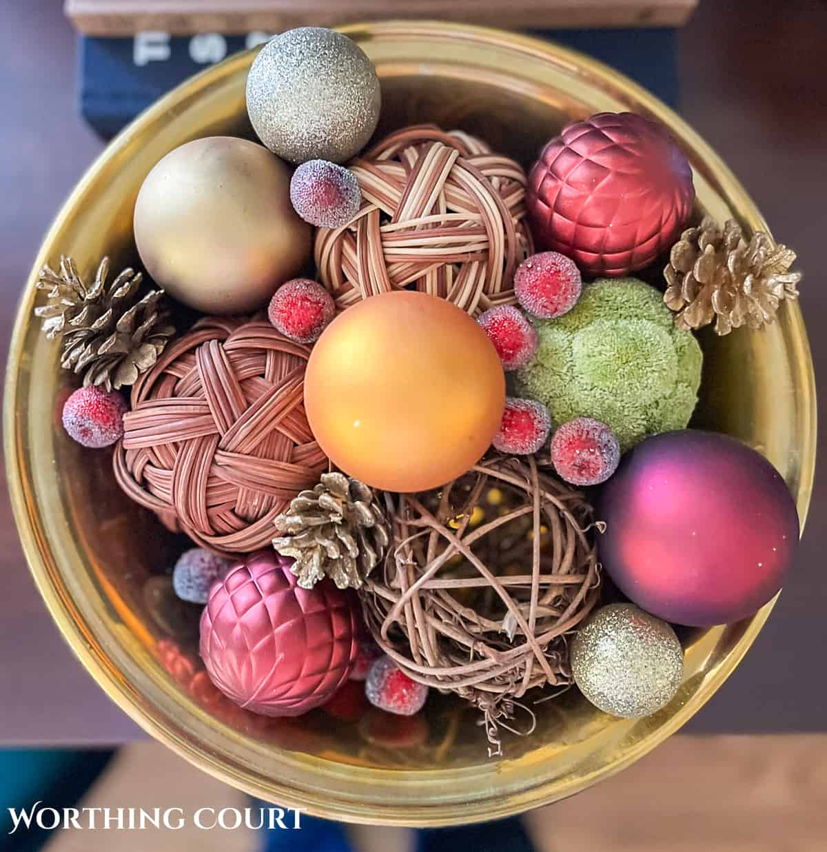decorative bowl of christmas ornaments and other baubles.