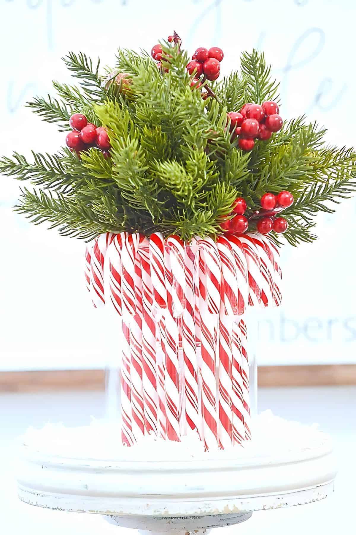 candy cane vase with greenery and berries