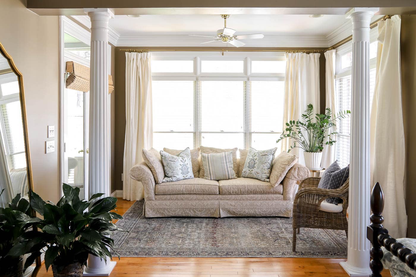 spring bedroom sitting area with floral spring throw pillows.