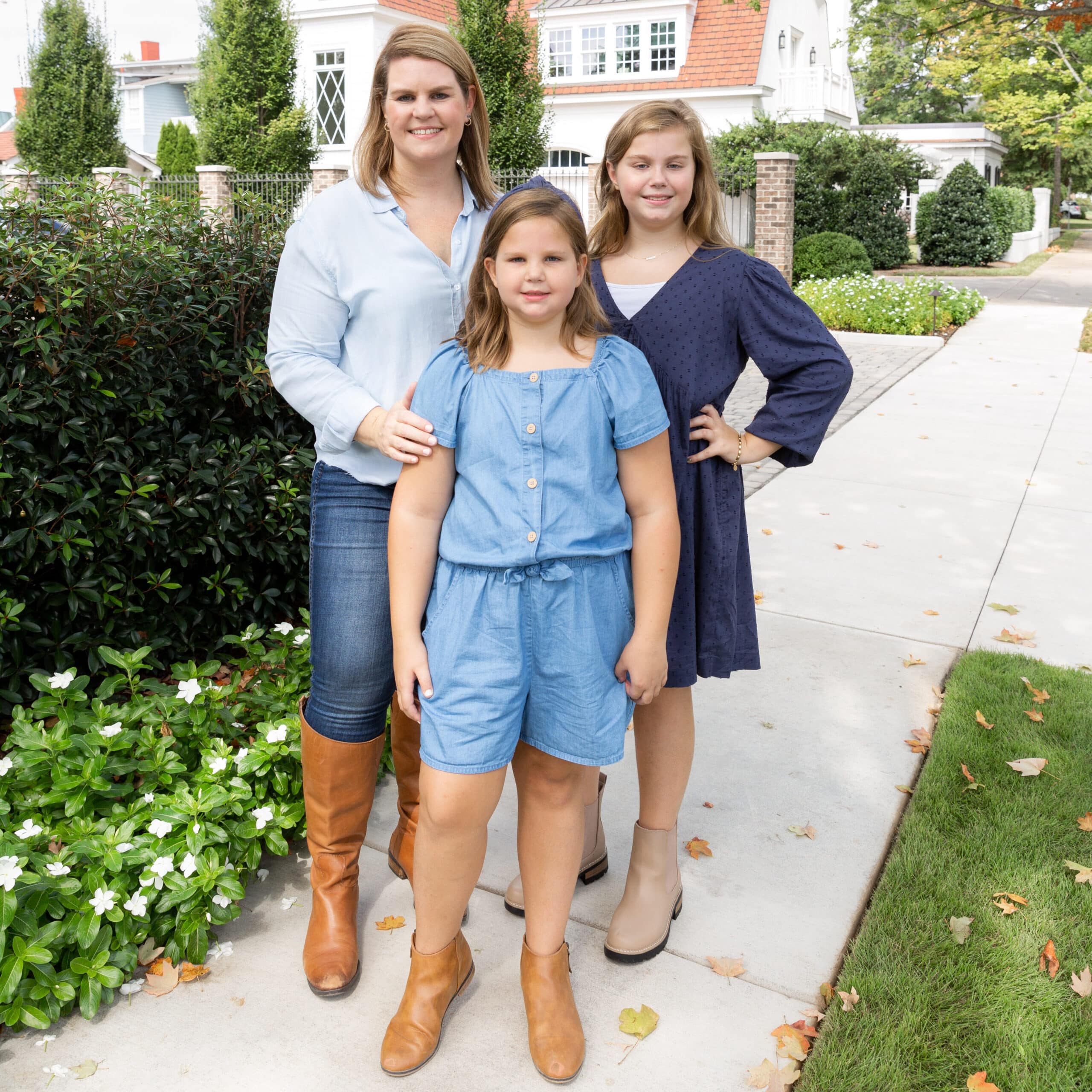 mom with two daughters standing outside a beautiful home on a sunny day – Mother’s Day gift ideas 2026
