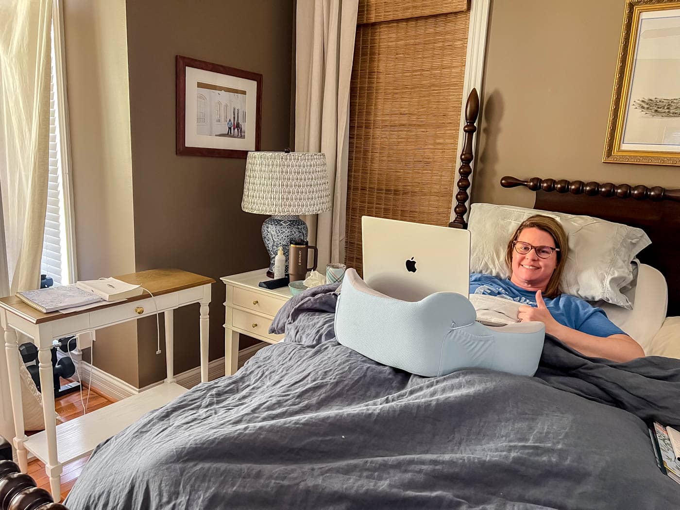 Working from home after surgery with a laptop pillow.