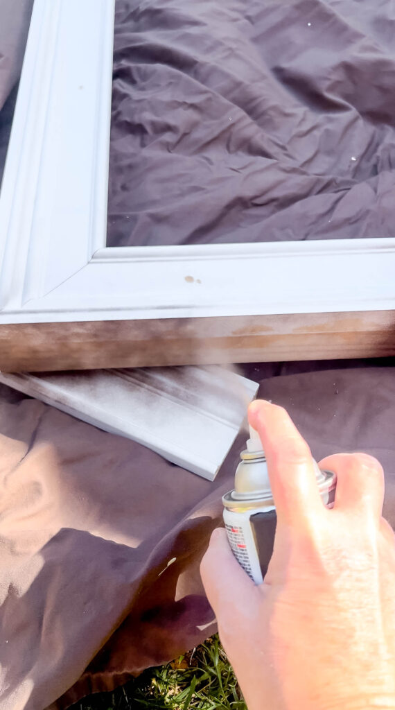 Spray painting the frame a dark brown color.