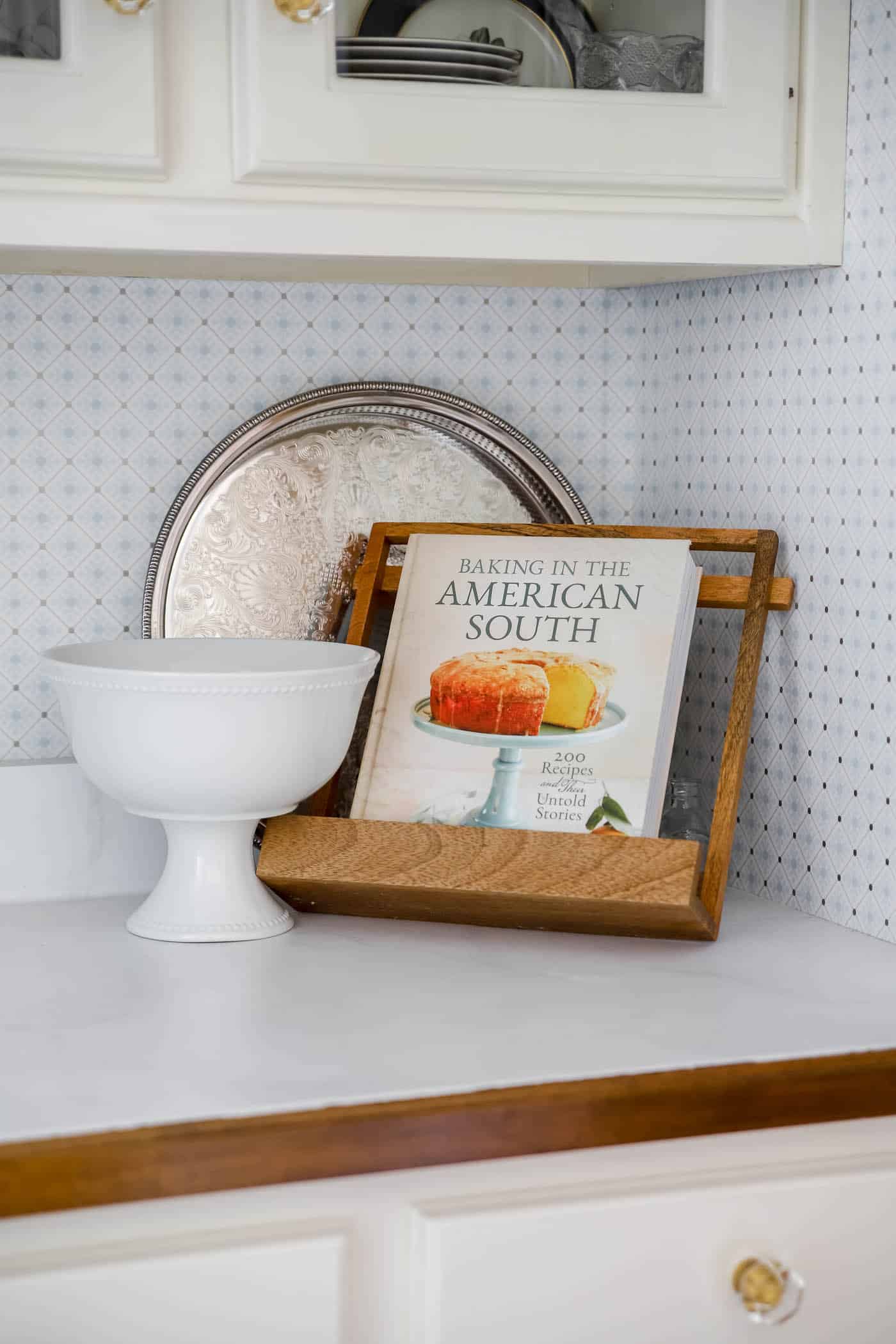 galleried silver tray stands up against the wall in a blue and white butler's pantry