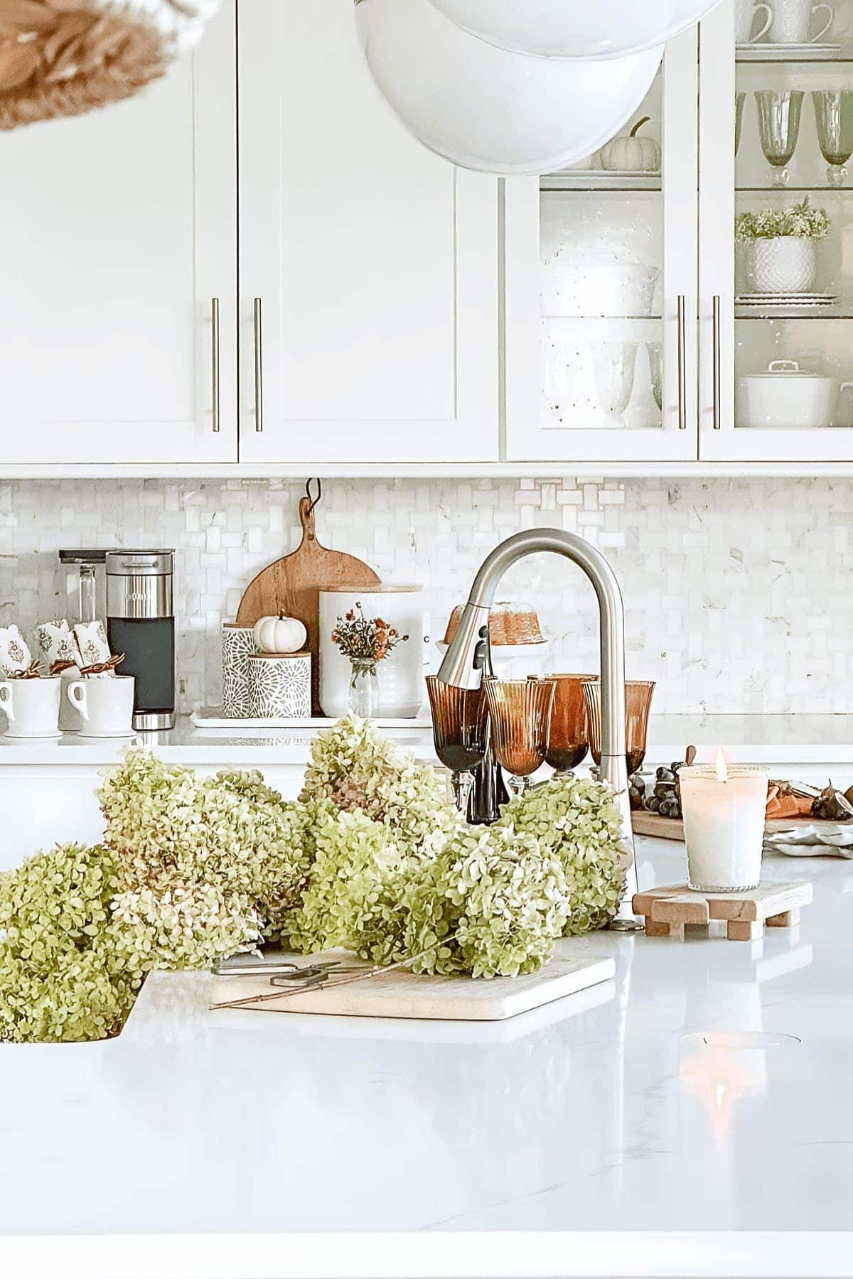 white kitchen with dried hydrangeas