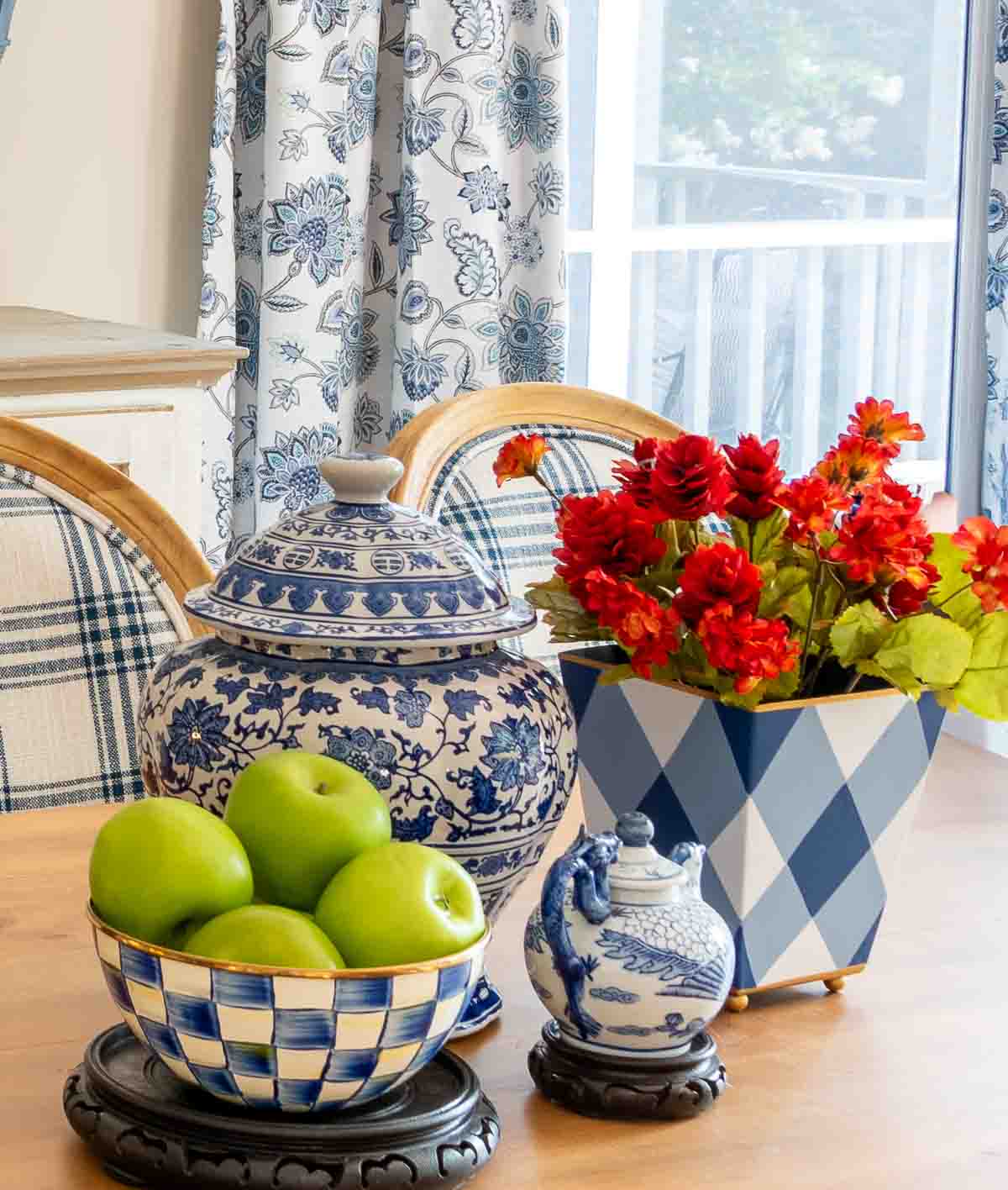 apples and blue and white decor on a table
