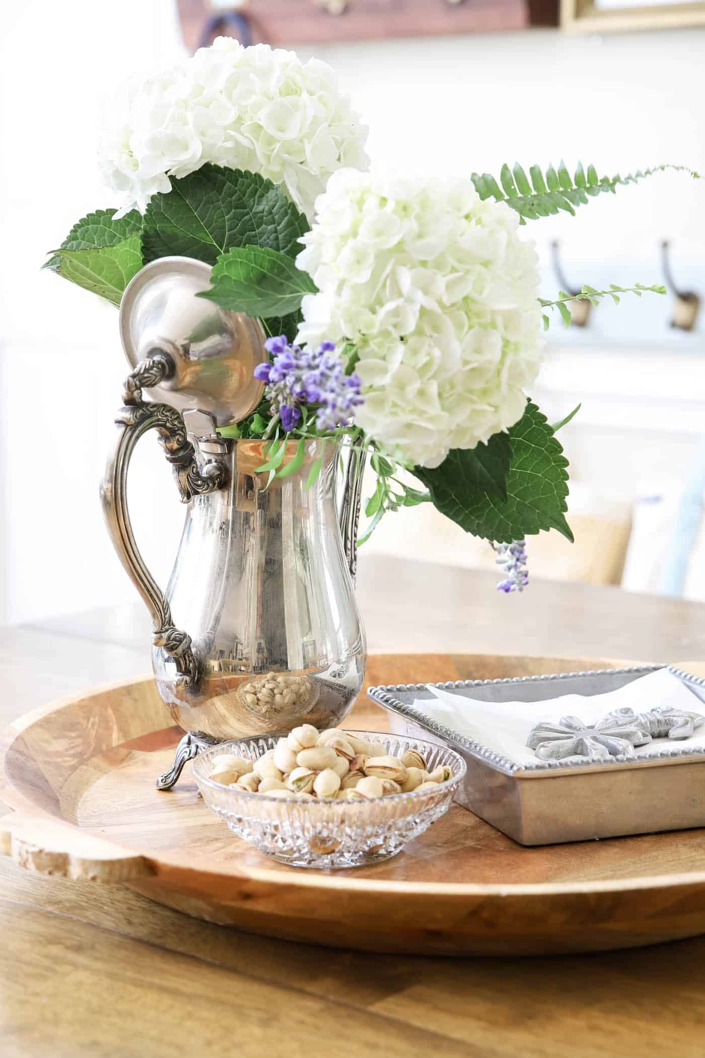 silver coffee pot as a flower vase on a kitchen table. 